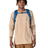 An adult wearing the The Patagonia Black Hole Backpack 25 litre capacity backpack, in endless blue.