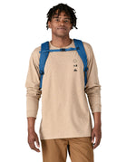 An adult wearing the The Patagonia Black Hole Backpack 25 litre capacity backpack, in endless blue.