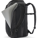 Patagonia Black Hole Pack 32L black travel backpack with laptop partially inserted in padded laptop compartment.