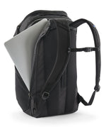 Patagonia Black Hole Pack 32L black travel backpack with laptop partially inserted in padded laptop compartment.