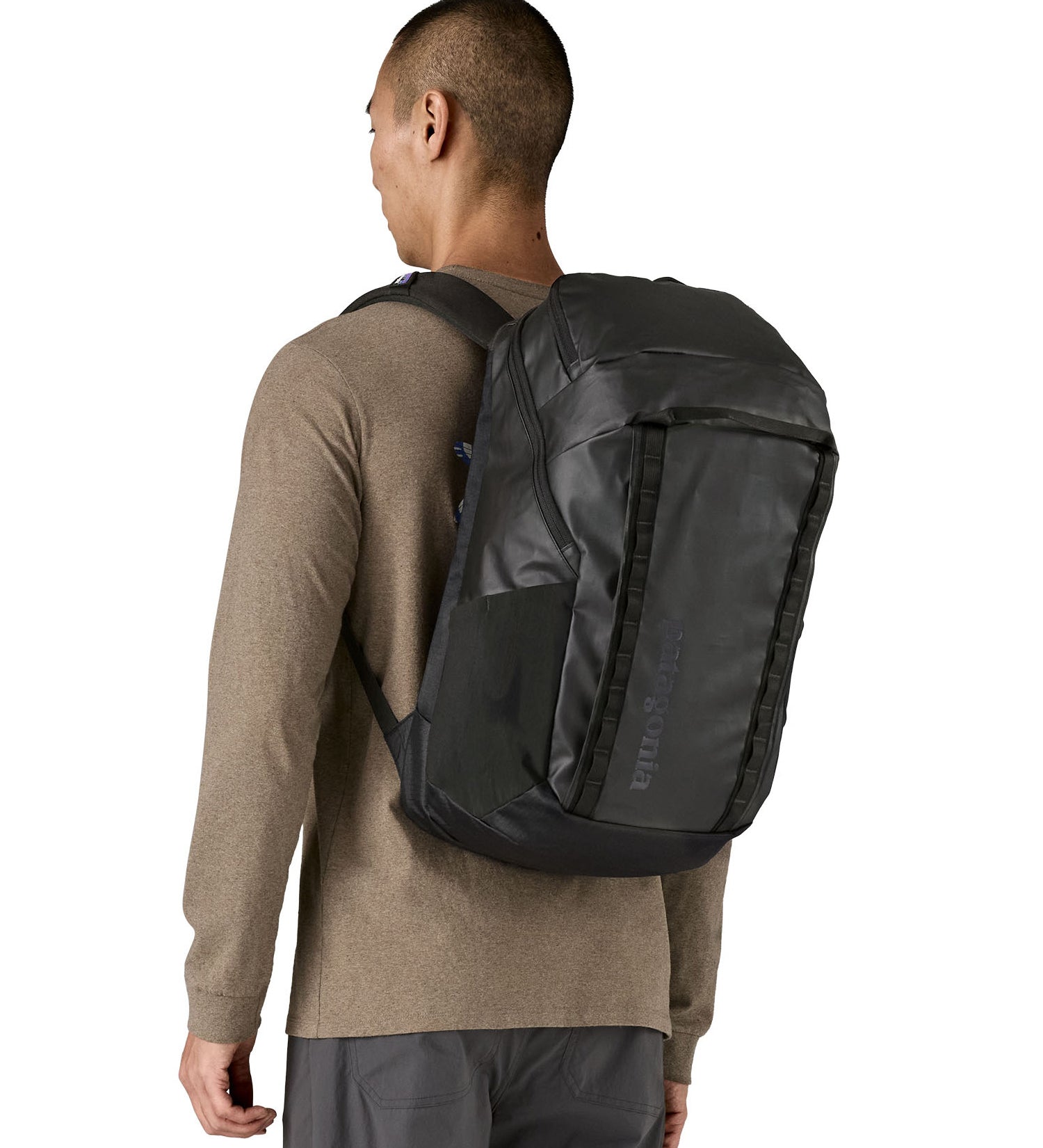 Person wearing the Patagonia Black Hole Pack 32L black travel backpack, demonstrating fit and size.