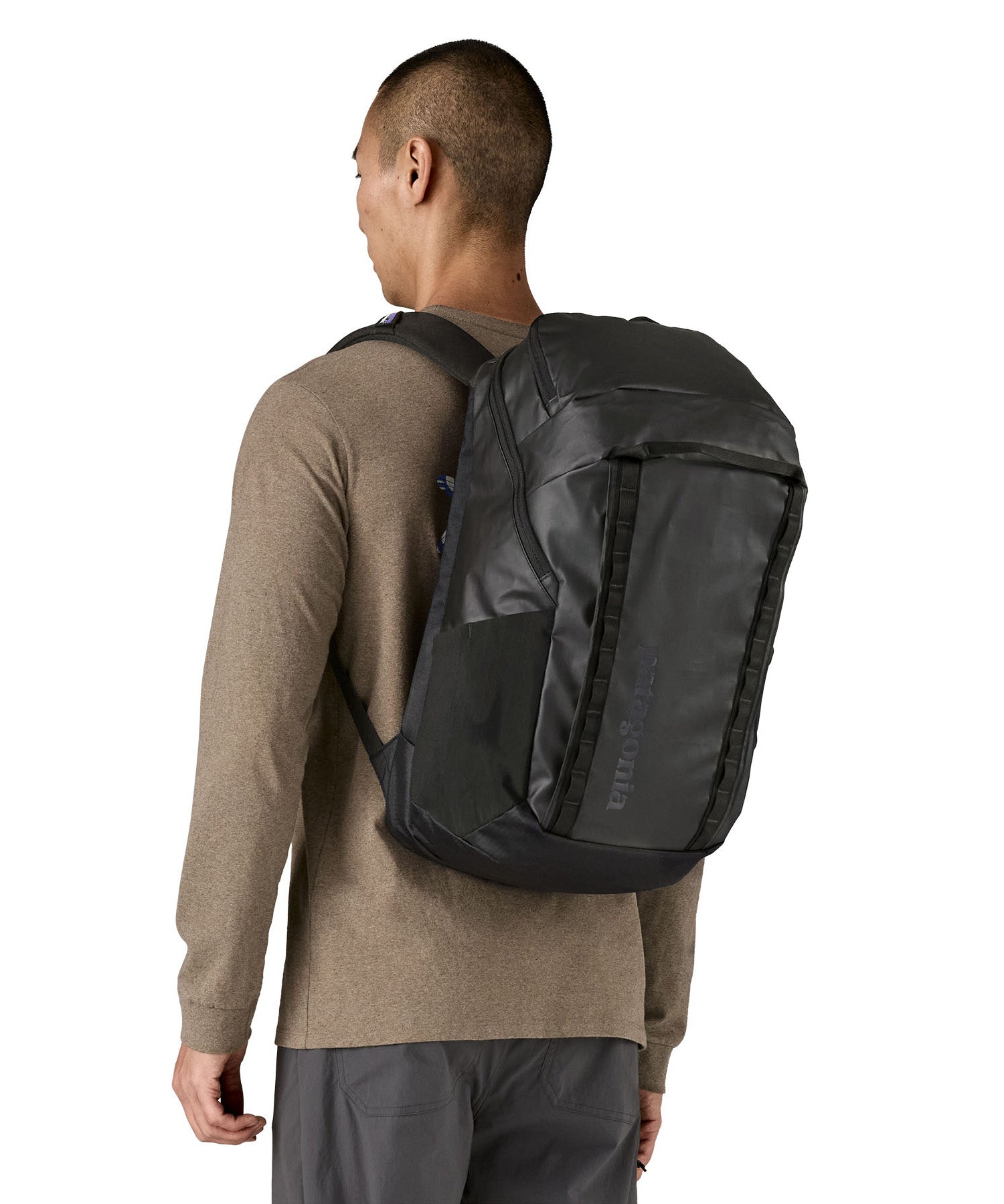 Person wearing the Patagonia Black Hole Pack 32L black travel backpack, demonstrating fit and size.
