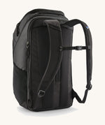 Patagonia Black Hole Pack 32L in black shown from the back, highlighting padded shoulder straps and travel backpack design.