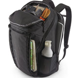 Patagonia Black Hole Pack 32L black shown open and filled with travel essentials, displaying internal organisation and side pockets.