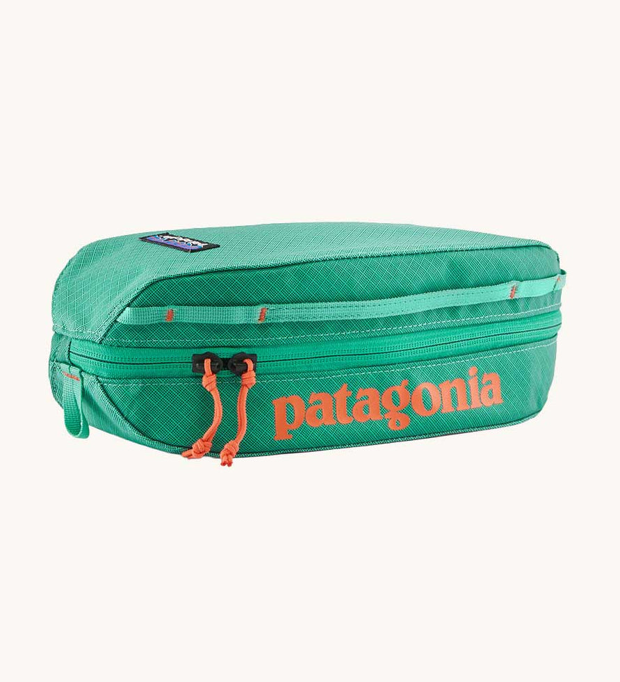 Patagonia black hole packing cube 3 litre in aqua stone with orange logo and zip pulls. 