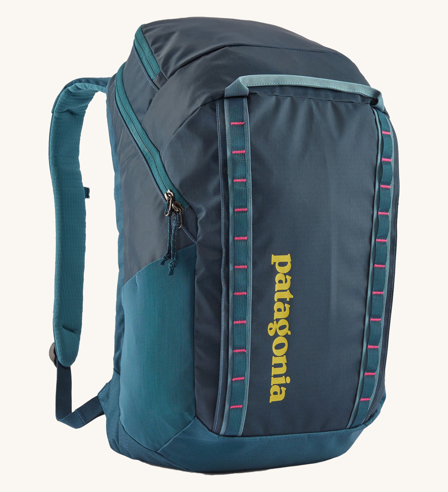 Patagonia 32L black hole backpack in a tidal teal colour on a cream background.