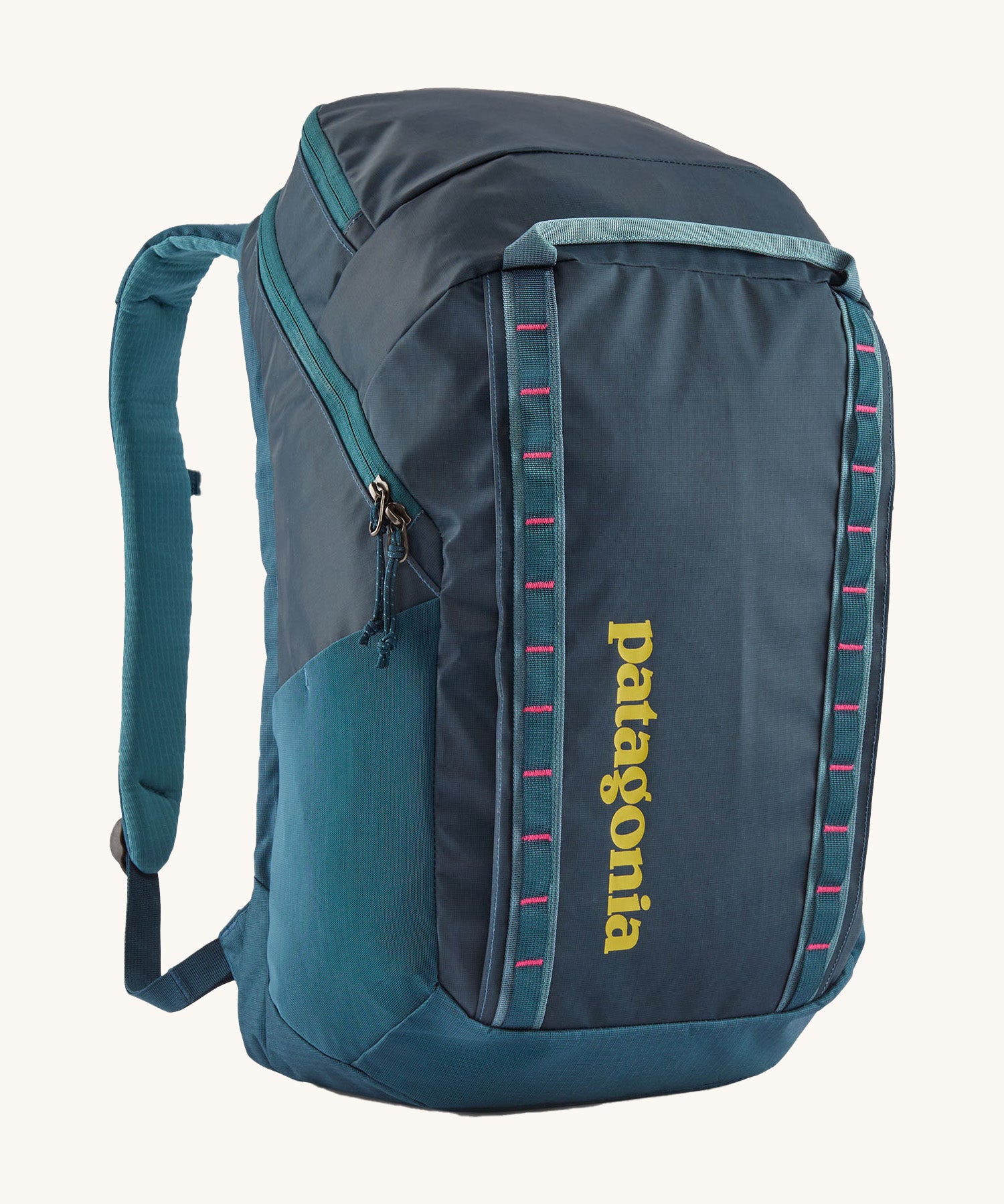 Patagonia 32L black hole backpack in a tidal teal colour on a cream background.