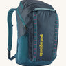 Patagonia 32L black hole backpack in a tidal teal colour on a cream background.