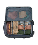 Patagonia 40L wheeled duffel bag fully packed with Patagonia clothes