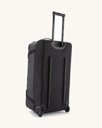 Patagonia black hole wheeled 100L duffel bag in black with pull up pull along handle.