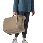 Patagonia 40L wheeled duffel bag being carried by a adult