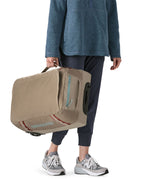 Patagonia 40L wheeled duffel bag being carried by a adult