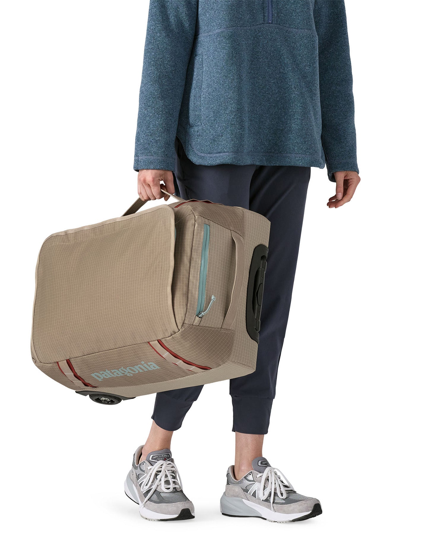 Patagonia 40L wheeled duffel bag being carried by a adult