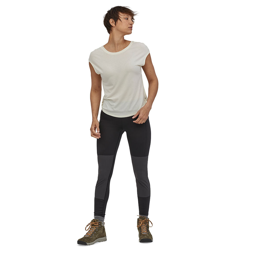 Woman stood on a white background wearing the Patagonia eco-friendly pack out hiking leggings in the black colour