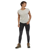 Woman stood on a white background wearing the Patagonia eco-friendly pack out hiking leggings in the black colour
