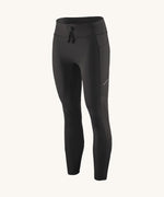 A pair of black Patagonia running 7/8 tights on a cream background.
