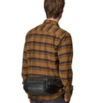 Patagonia 5L waist pack in a black colour worn by an adult