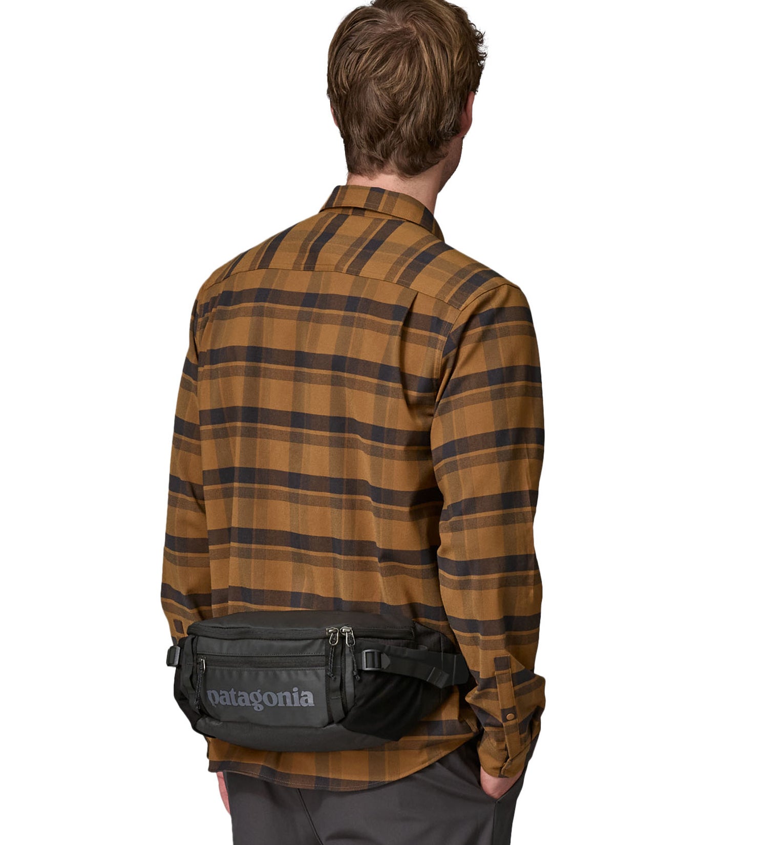 Patagonia 5L waist pack in a black colour worn by an adult
