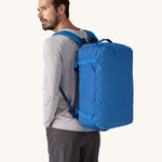 A man wearing a 40L Patagonia duffel bag on his back. 