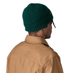 The back of a man wearing the Patagonia adult brodeo beanie hat on cascade green available at Babipur.