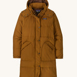 Patagonia parka in a brown colour on a cream background.
