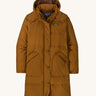 Patagonia parka in a brown colour on a cream background.