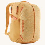 Patagonia yellow 26L day refugio backpack with a buttercup design on a cream background.