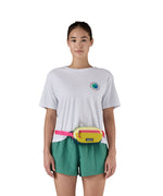 A woman modelling the Patagonia mini Terravia bum bag, with the strap fastened around her middle and the hip pack resting at her waist.