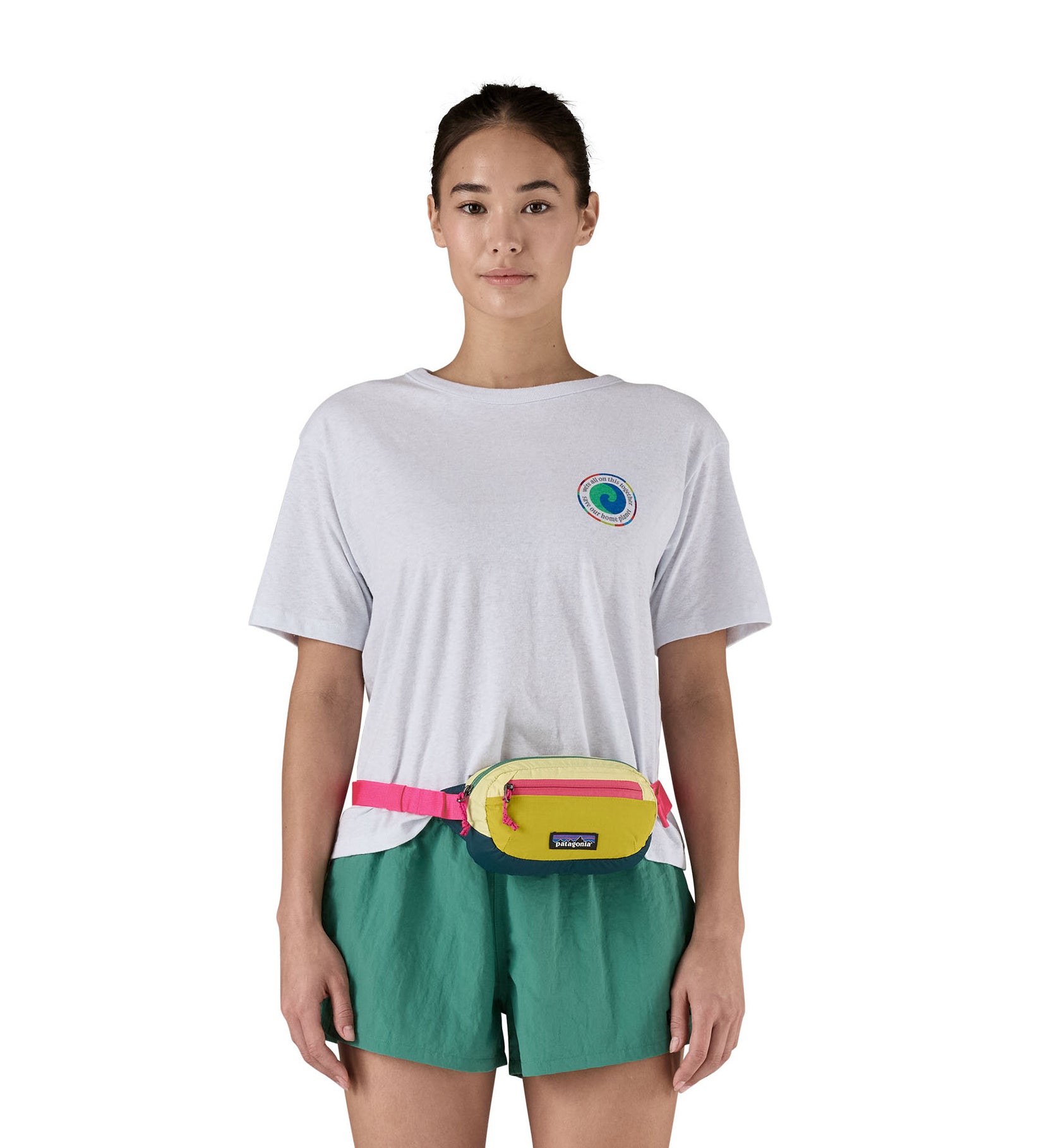 A woman modelling the Patagonia mini Terravia bum bag, with the strap fastened around her middle and the hip pack resting at her waist.