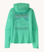Back of Patagonia women's capilene cool sun hoody in aqua stone teal X-Dye with peak visions graphic on the back