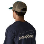 The back of a man wearing the Patagonia adult cascade green hat. A trucker style cap with a mesh back and logo embroidery on the front panel available at Babipur.