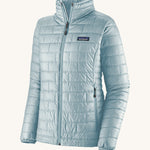 Patagonia women's nano puffer jacket in a chilled blue colour on a cream background.
