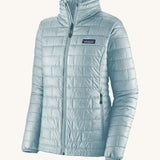 Patagonia women's nano puffer jacket in a chilled blue colour on a cream background.