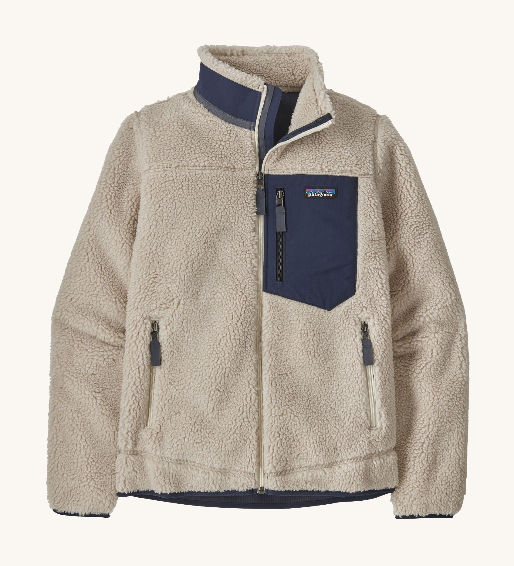 Patagonia women's retro-x fleece in a natural cream colour with a navy check pocket and collar on a cream background.