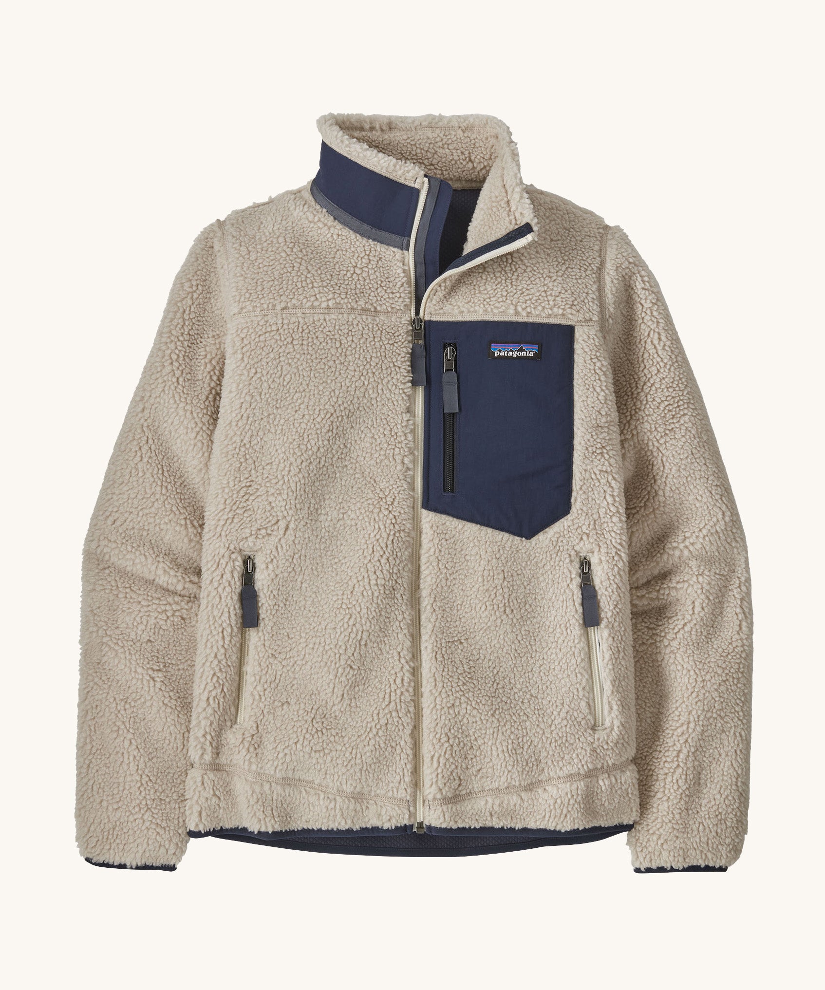 Patagonia women's retro-x fleece in a natural cream colour with a navy check pocket and collar on a cream background.