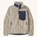 Patagonia women's retro-x fleece in a natural cream colour with a navy check pocket and collar on a cream background.