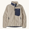 Patagonia women's retro-x fleece in a natural cream colour with a navy check pocket and collar on a cream background.