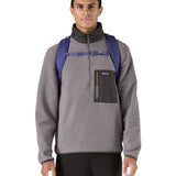 Patagonia purple 26L day refugio backpack worn by an adult shoulder straps and clip detail