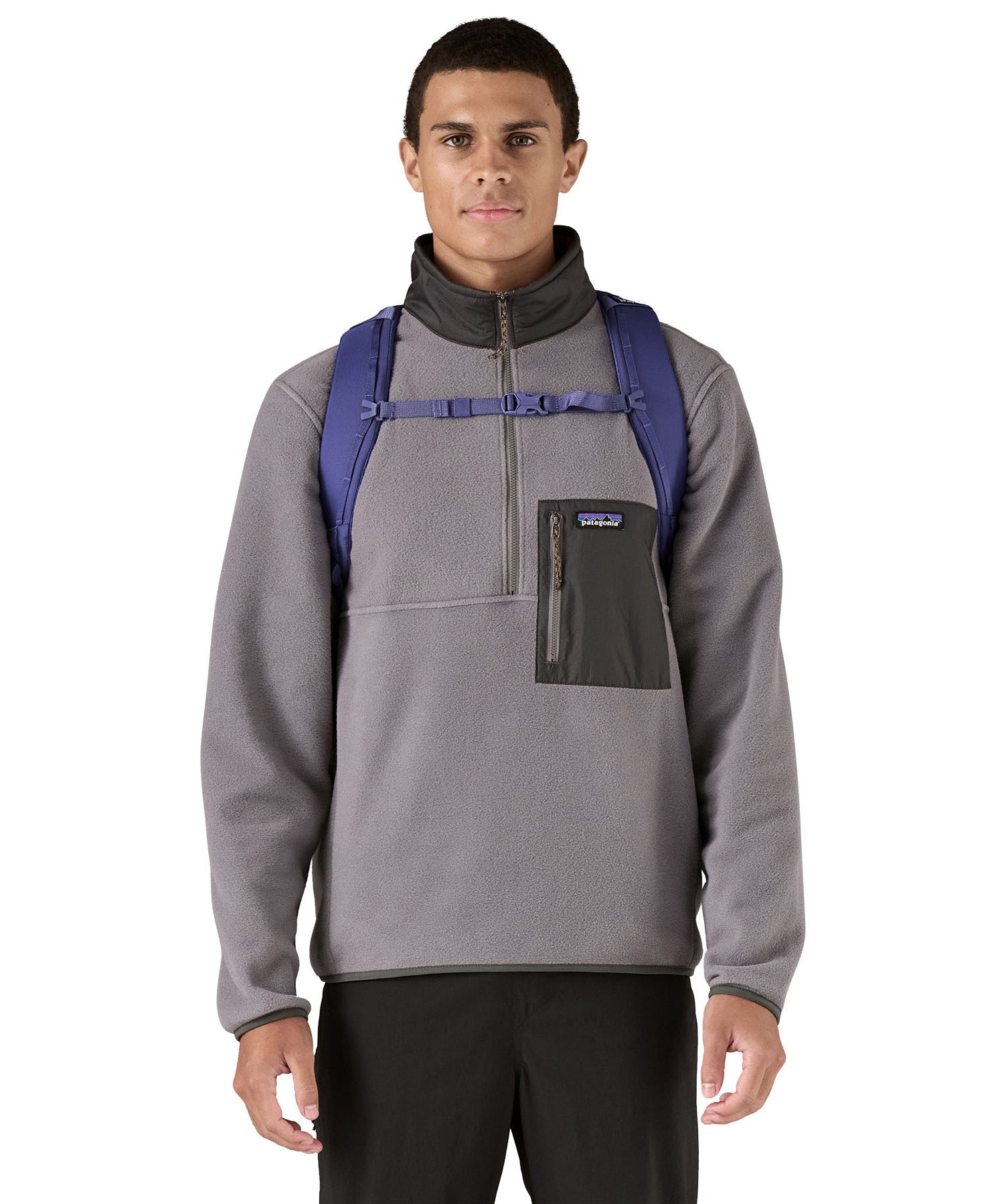 Patagonia purple 26L day refugio backpack worn by an adult shoulder straps and clip detail