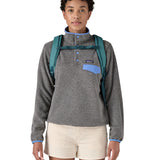Patagonia turquoise 26L day refugio backpack worn by an adult shoulder straps and clip detail