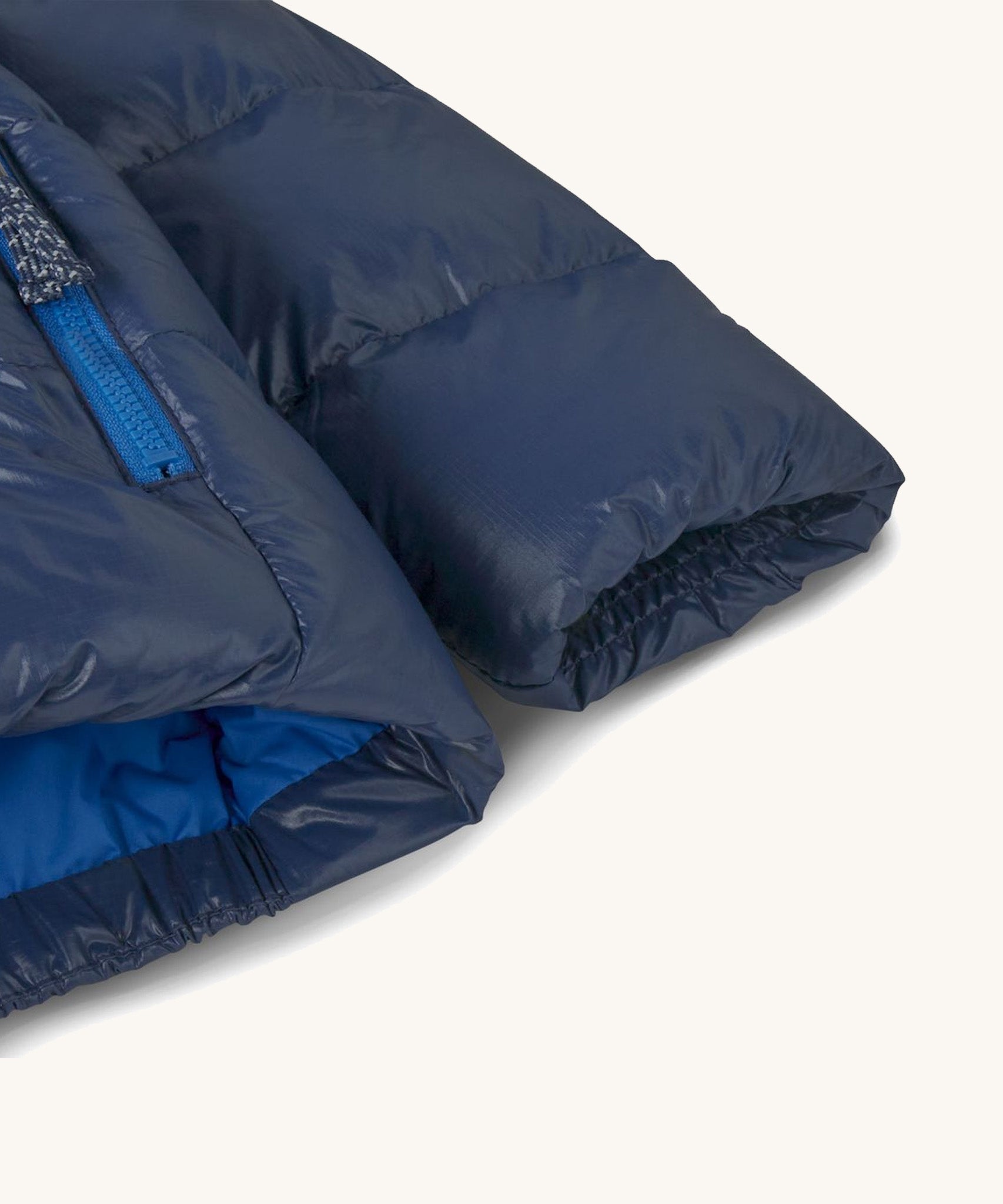 A close up of the Patagonia down jacket in new navy showing the arm cuff detailing. Coat is available at Babipur