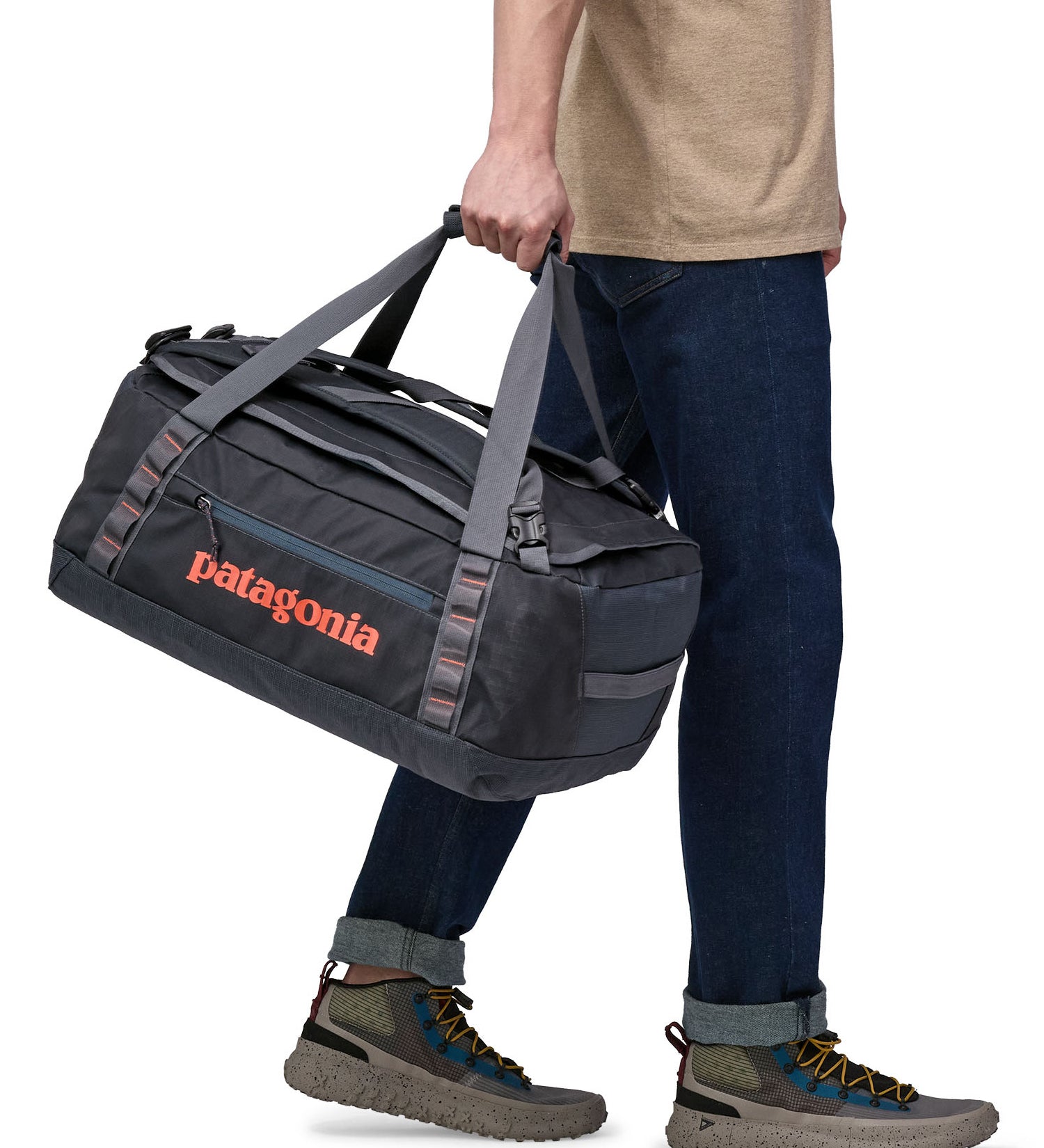 Patagonia 40 litres duffel bag in a dark navy blue colour held by an adult.