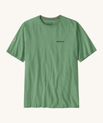 Patagonia mens Fitz roy responsibili top. A green cotton long sleeve t-shirt showing the brand name printed on the left chest and a small badge icon on the right sleeve.