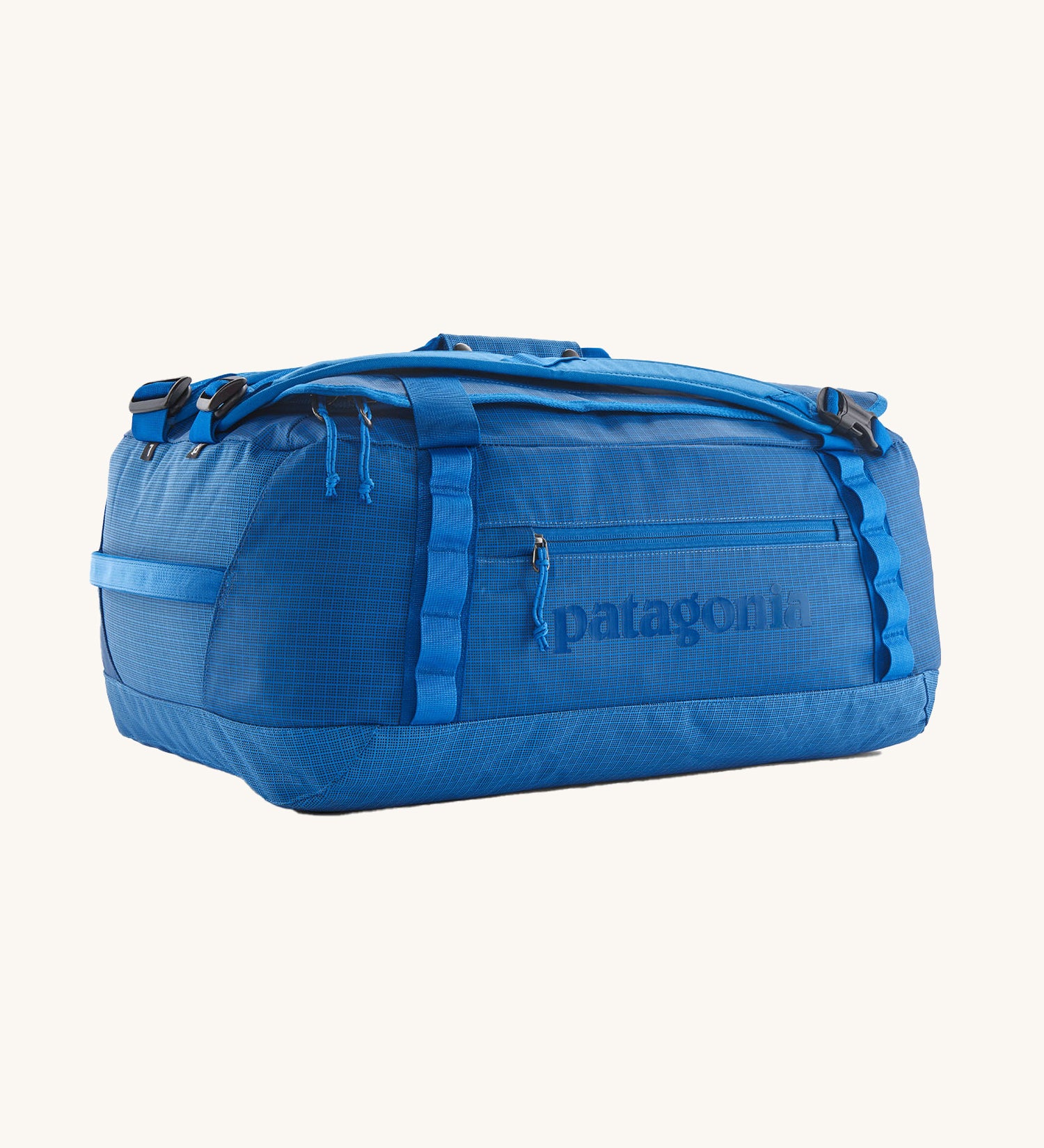 Patagonia black hole duffel bag in endless blue colour on a cream background
