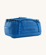 Patagonia black hole duffel bag in endless blue colour on a cream background