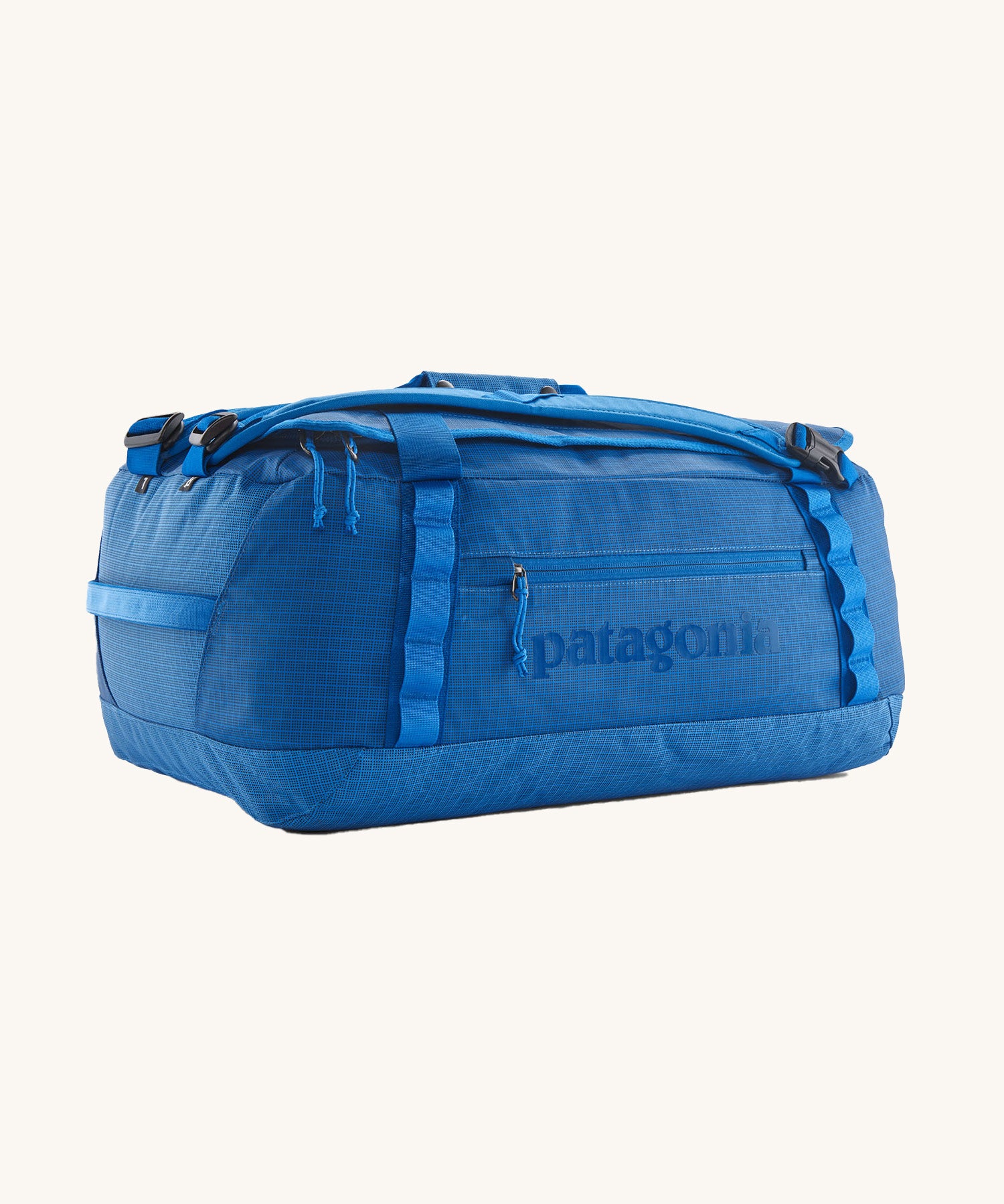 Patagonia black hole duffel bag in endless blue colour on a cream background