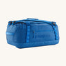 Patagonia black hole duffel bag in endless blue colour on a cream background