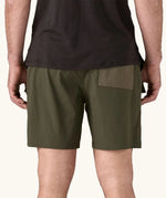 Back of the Patagonia Men's Outdoor Everyday Shorts in Pine Needle Green being worn.