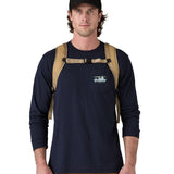 Person wearing a Patagonia fieldsmith roll top backpack in classic tan with chest strap with quick-release buckle.
