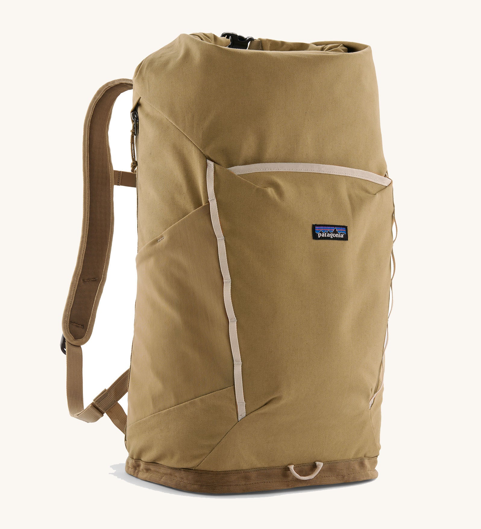 Patagonia fieldsmith roll top backpack in classic tan with zipped compartments and small blag logo tag on front.